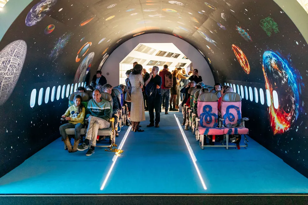 Visitors in an exhibition space designed as the interior of a spaceship
